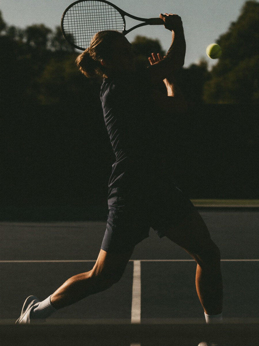 Adult tennis player hitting a forehand during a private lesson